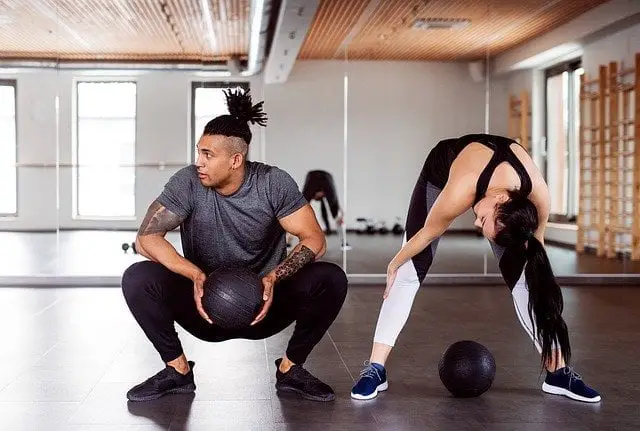 Man and woman at the gym - importance of exercise